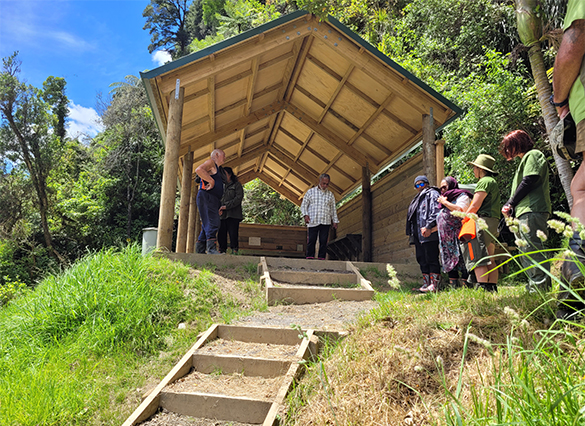 Church minister Robbie Williams blesses the new shelter at Mangapurua