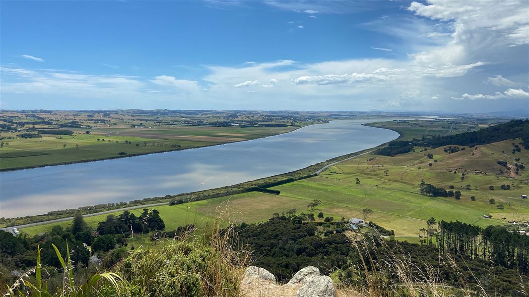 View of river and farmland from hill.