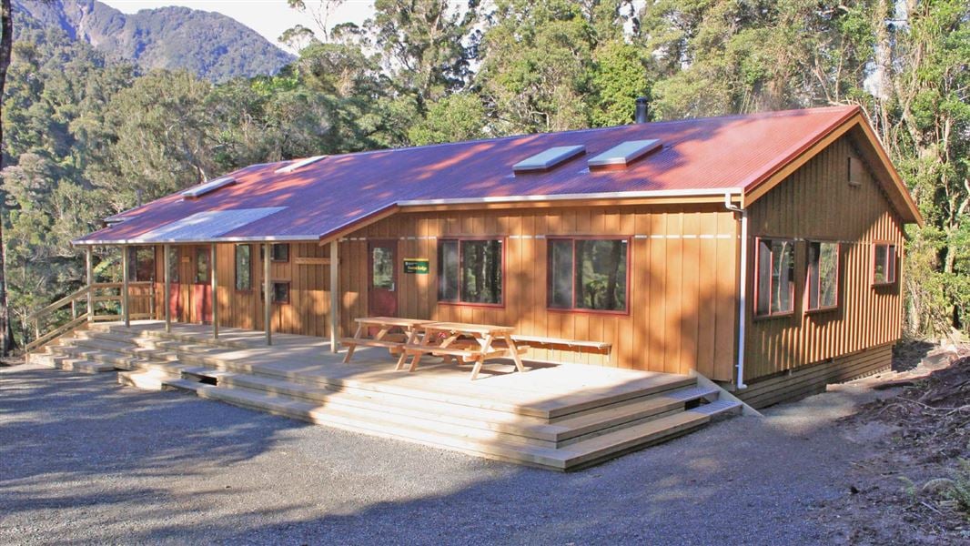 A large yellow hut with a red roof. 