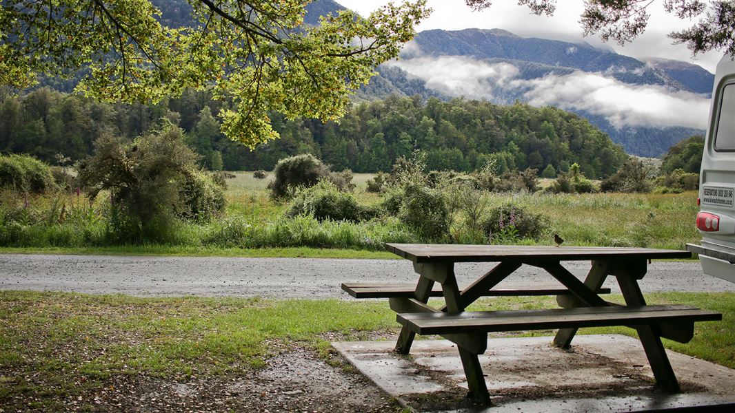 Picnic table with view of hills and trees.