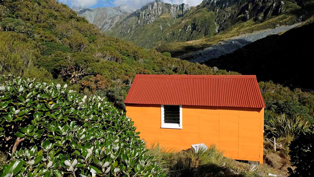 Small orange hut in building.