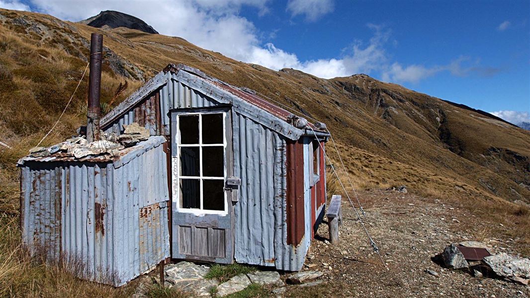 View of a battered Heather Jock Hut in the Whakaari Conservation Area.