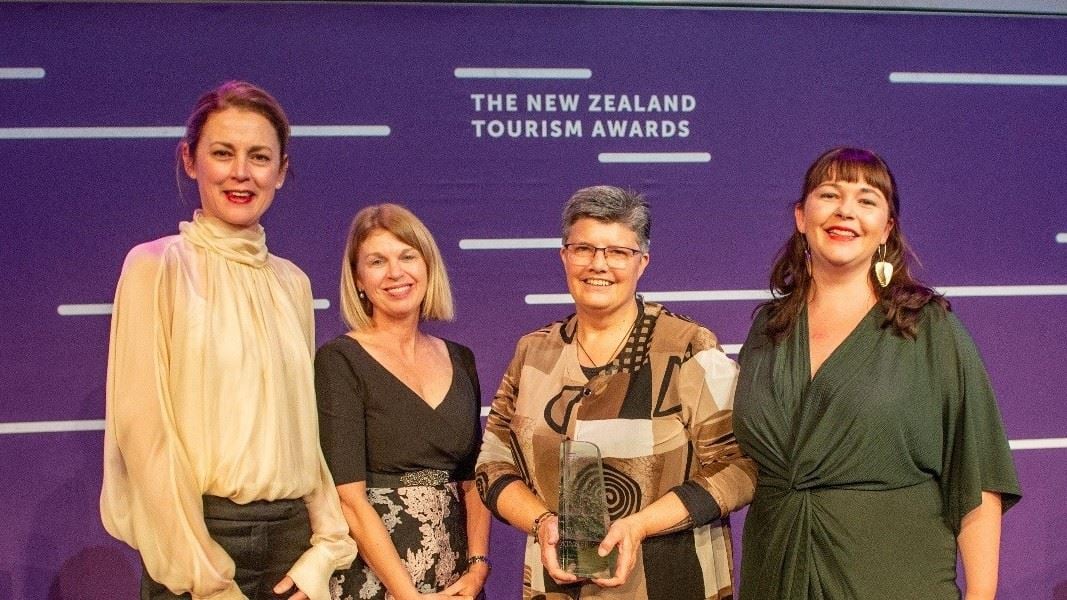 Three representatives from DOC collect the Great Journeys of New Zealand Industry Enabler Award