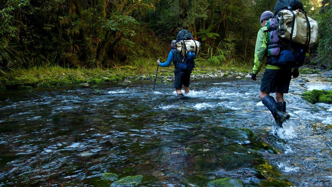 Trampers crossing the Pearse River 