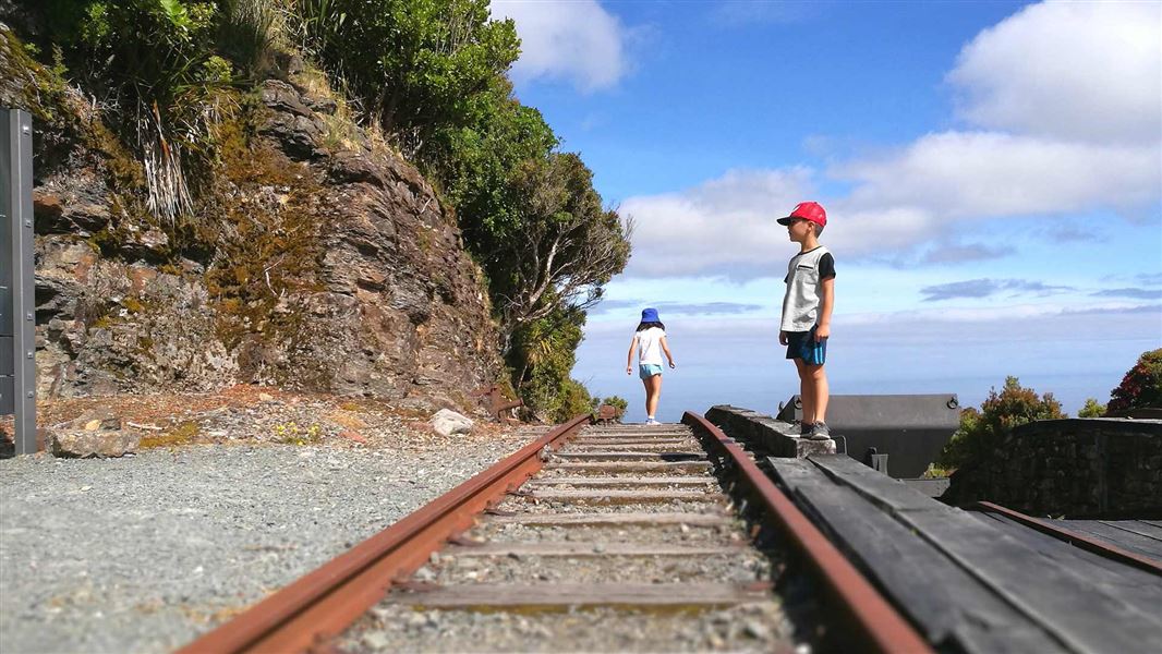 Children on the tracks at Denniston. 