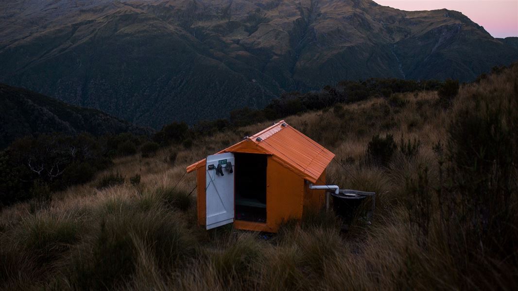 Small orange building on hill.