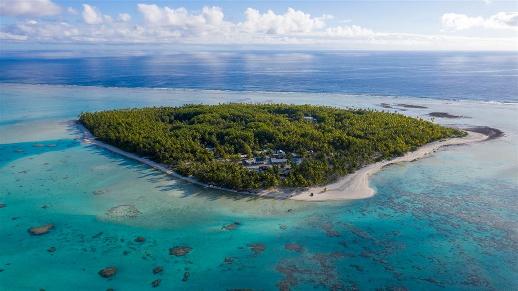 Pacific island surrounded with turquoise ocean.