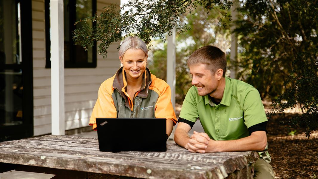 Two DOC rangers working outside on a sunny day at the DOC Masterton Office.