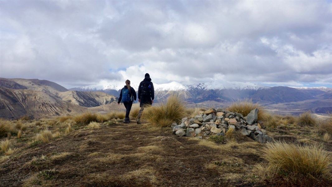 people walking on top of hill.