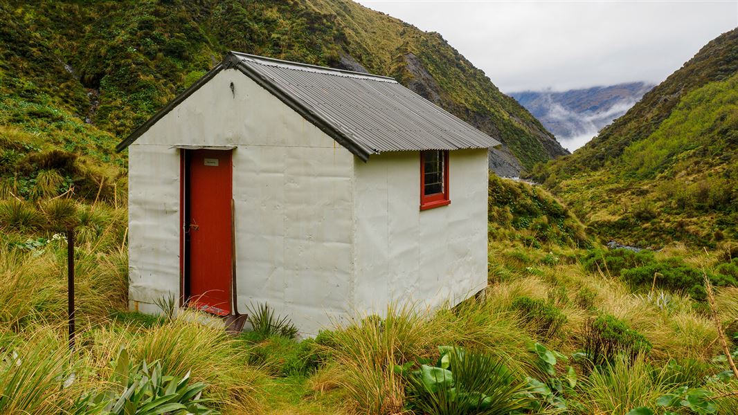 Small building by hills.