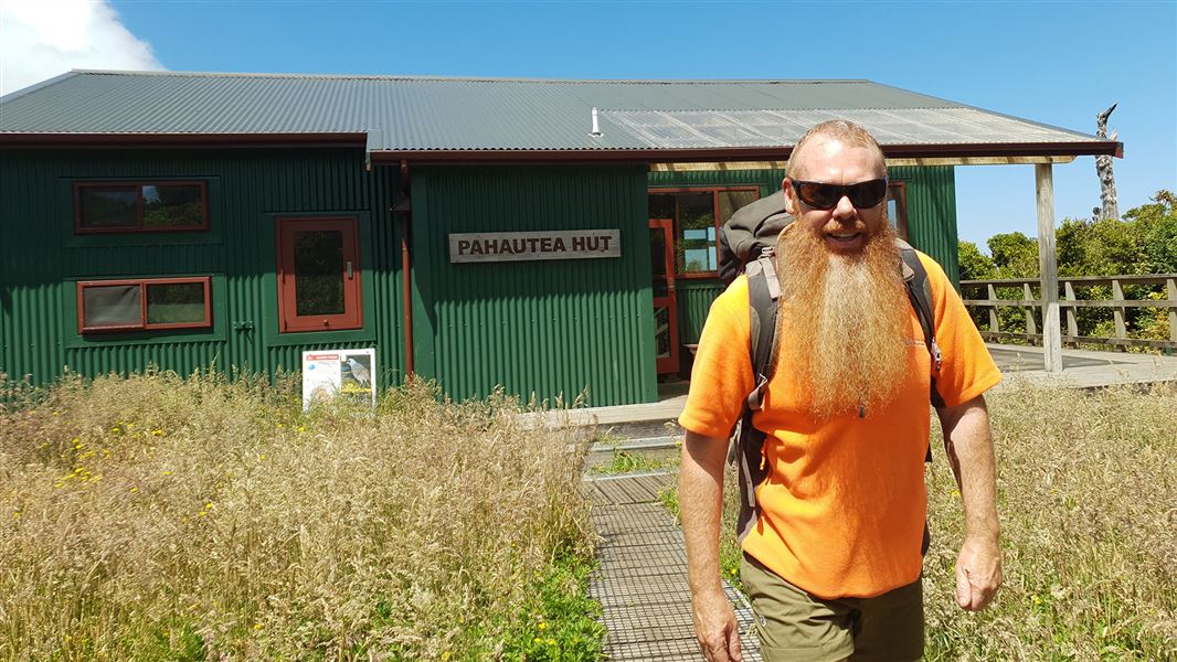 Hut with man in front.