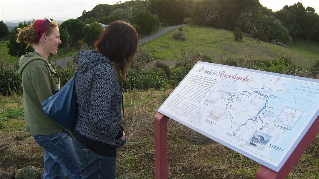 People reading interpretation panel. 