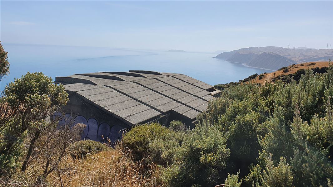 View of sea and concrete buildings.