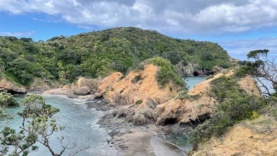 View from ridge down onto rocky coastal head.