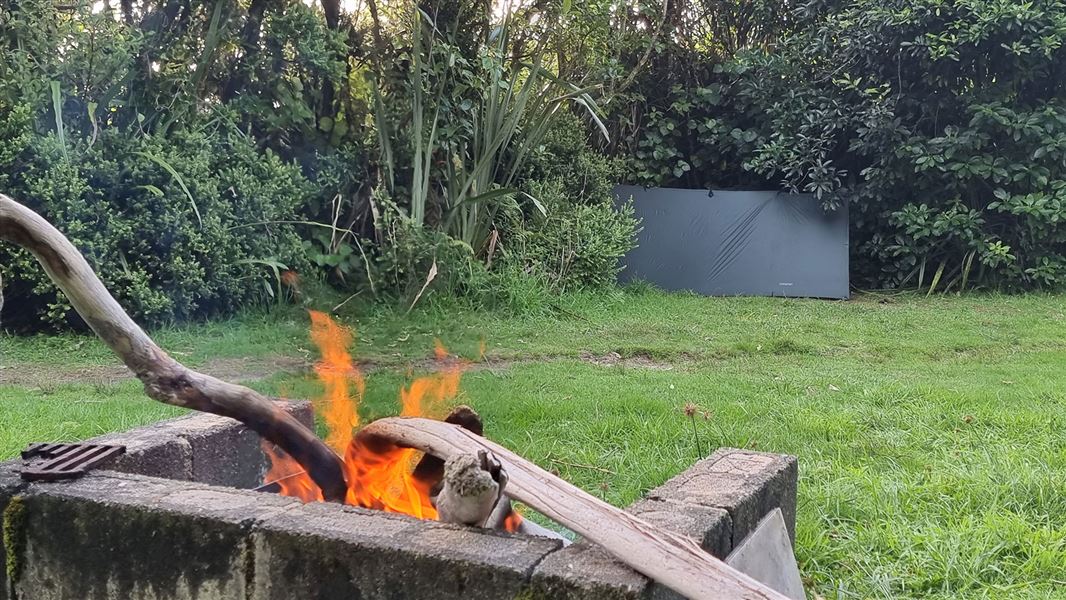 Fire pit in grassy area.