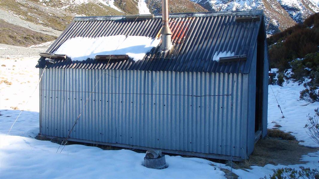 A snow covered small hut