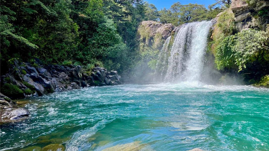 Waterfall flowing into rock pool. 