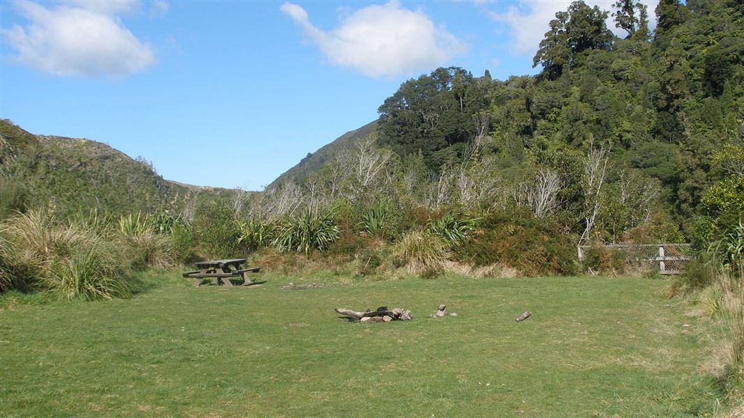 Campsite camping area with picnic seat.