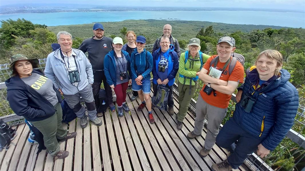 Group photo of delegation with ocean in the background.