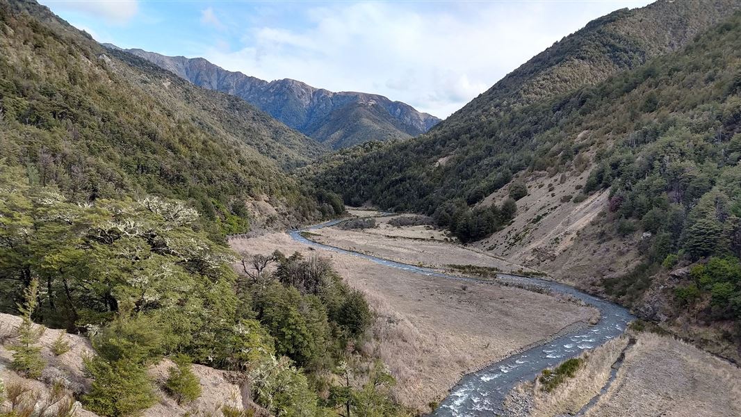 Riverbed surrounded by hills.