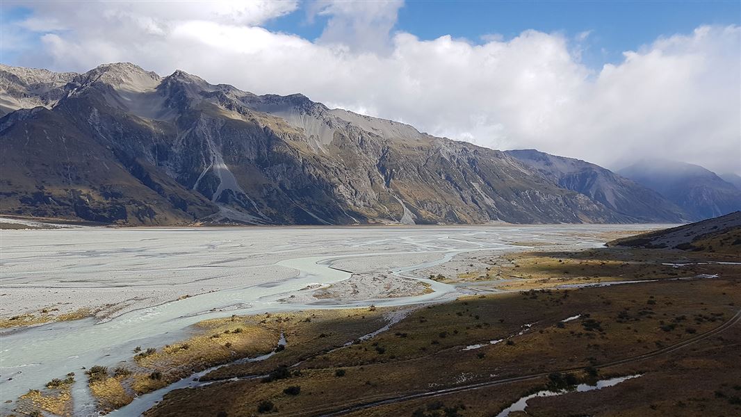 Riverbed by hills.