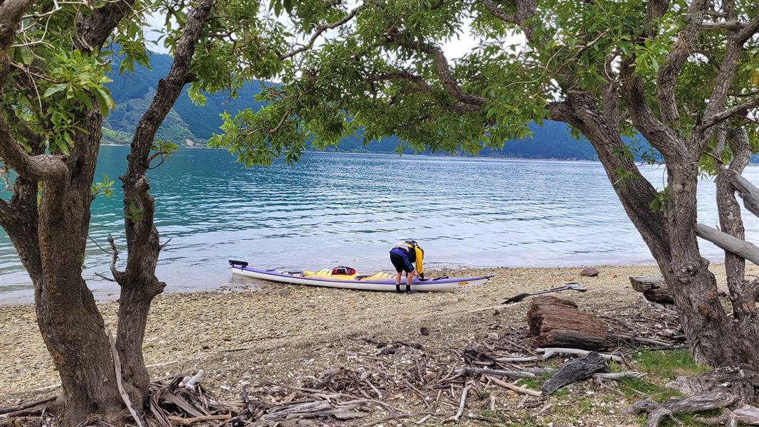 A kayaker readies their kayak on Pipi Beach.