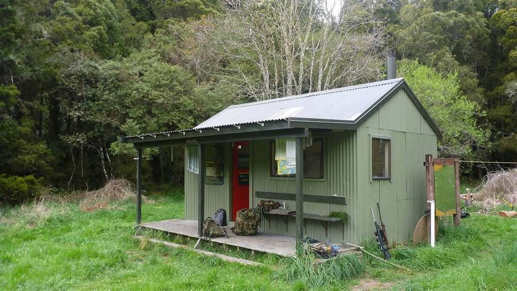 Small building by trees.