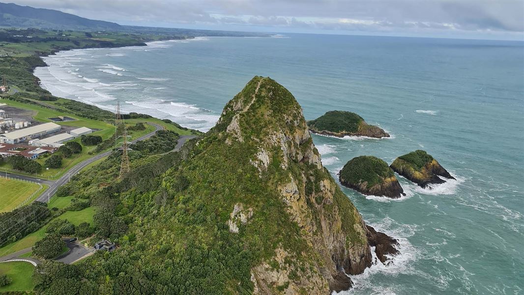 An aerial view over a rocky coast and islands.