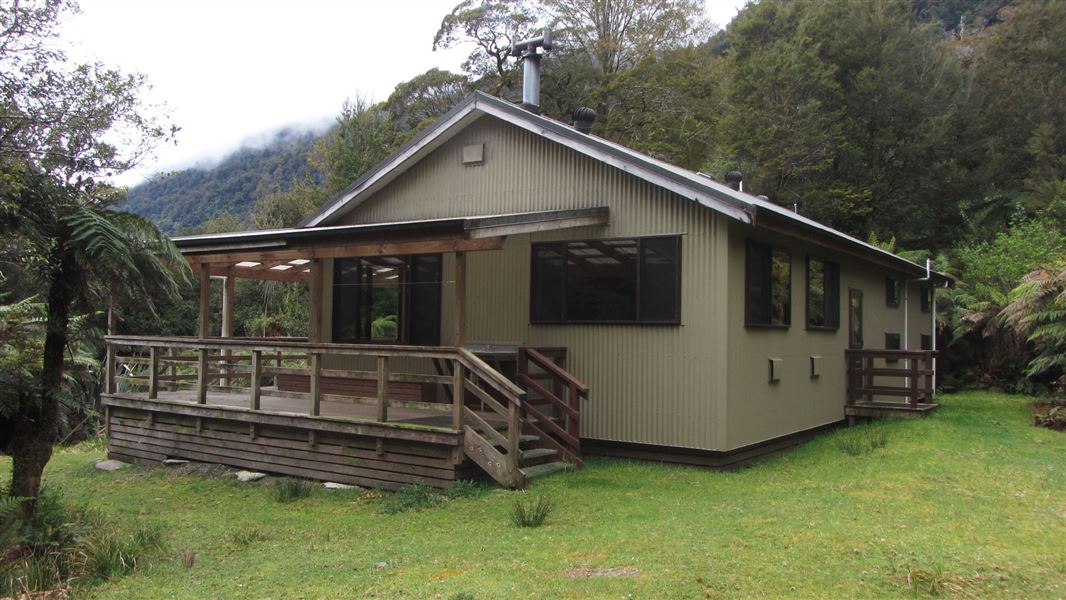 Small building by trees.