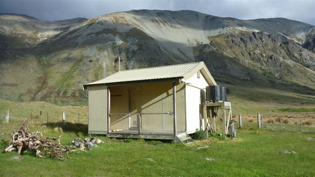 Small building near hills.