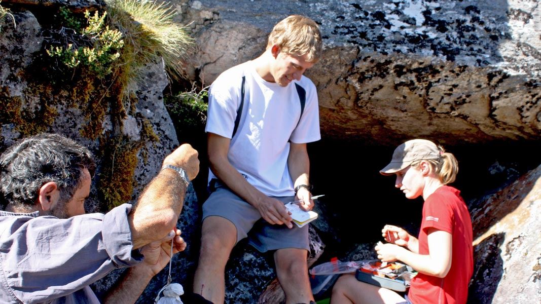 Researchers in rocky surroundings. 