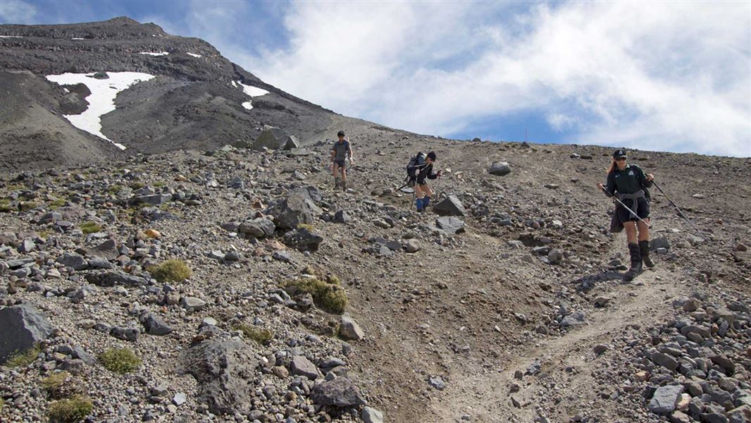 Descending the scoria slopes on the Taranaki Maunga Summit Track. 