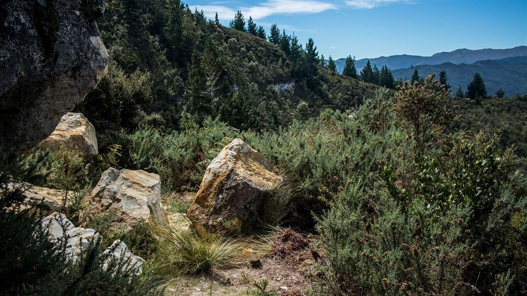 Rocks at top o hill with view of area.