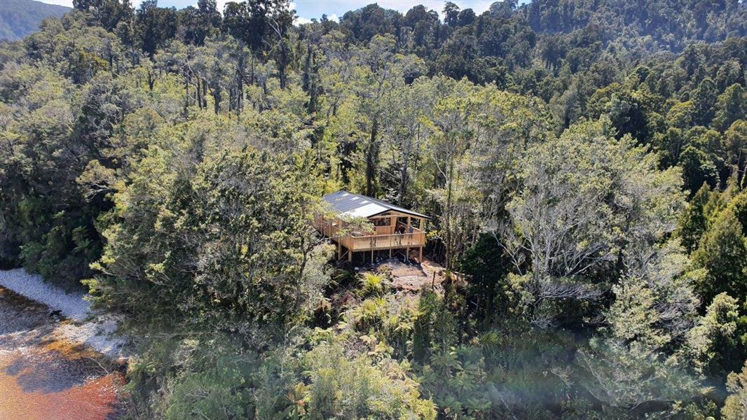 Single story building among trees.