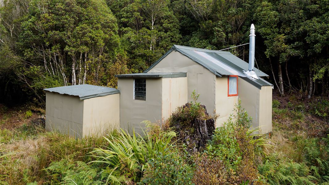 Small building near trees.