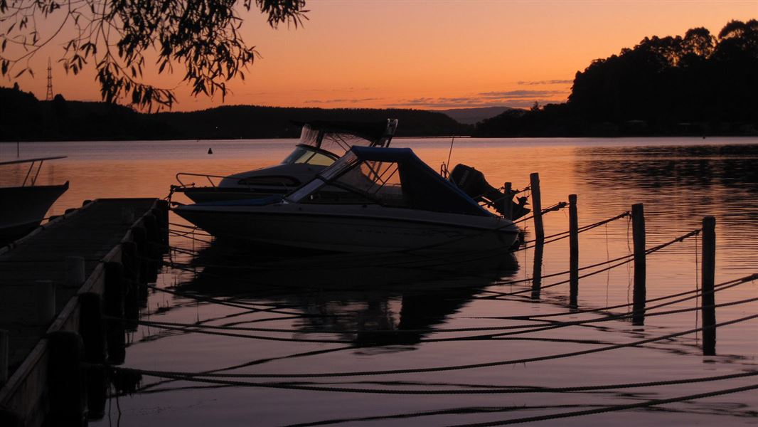 Boat on Lake Rotoiti at sunset. 