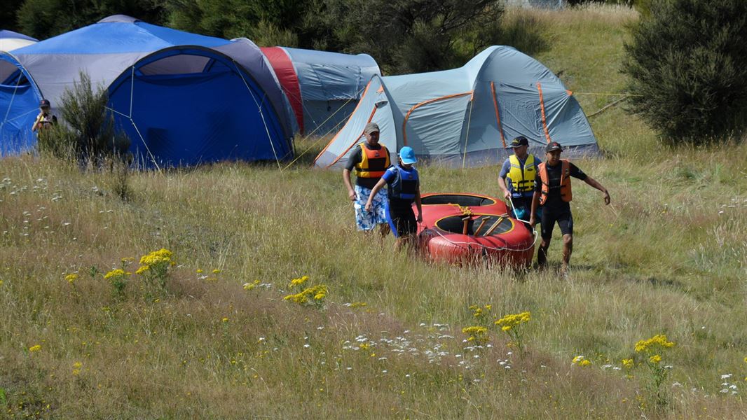 Campers taking their raft down to the Ngaruroro River. 