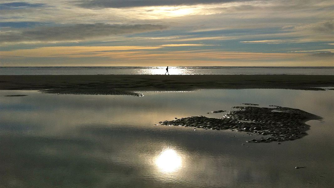 Walking on the beach at Raglan. 