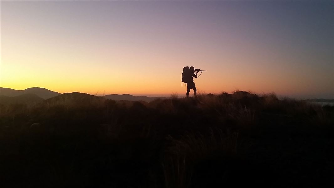 Recreational hunter with colourful sky. 