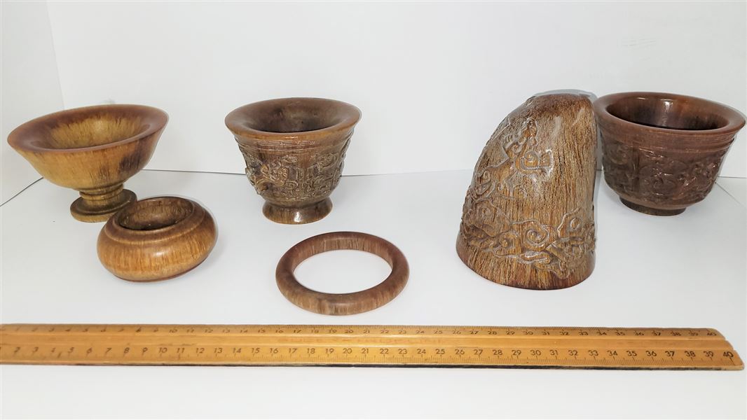 Seized rhino horn items: two small bowls, bangle and an ornament, with a ruler for scale. 