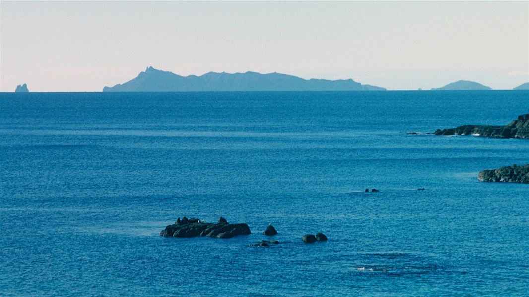 Islands in the distance of a hazy ocean.