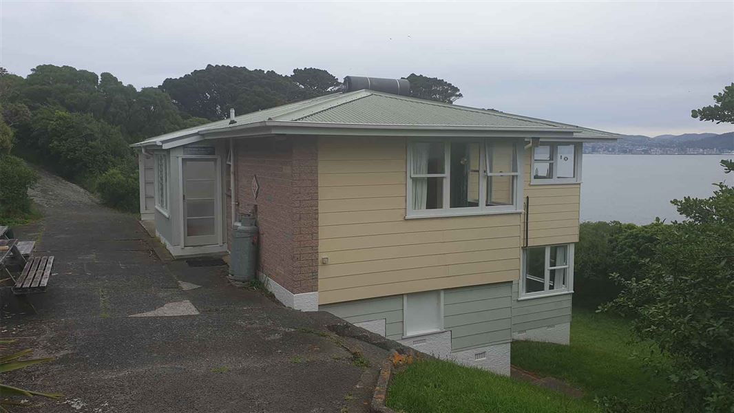 A two storey mainly wooden house with views towards Wellington City