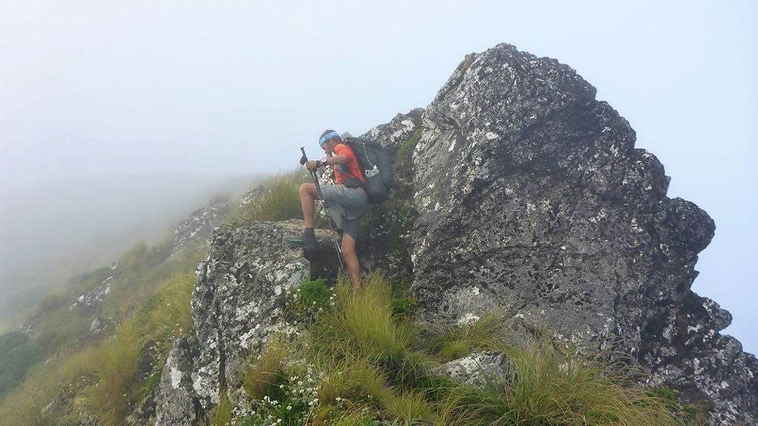 Tramper on rocky terrain on the Tararua Ranges.