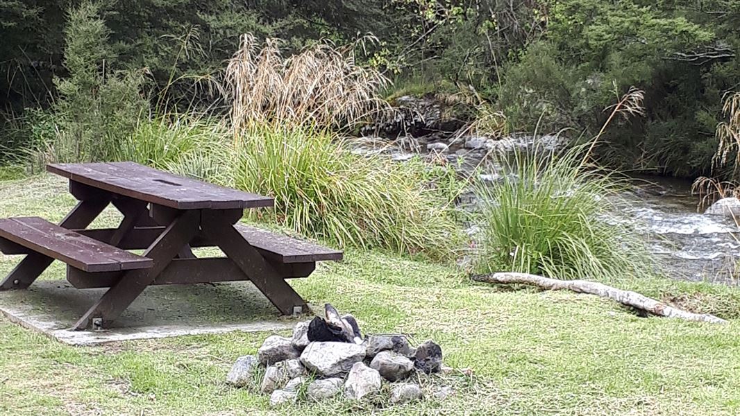 Wooden table near river.