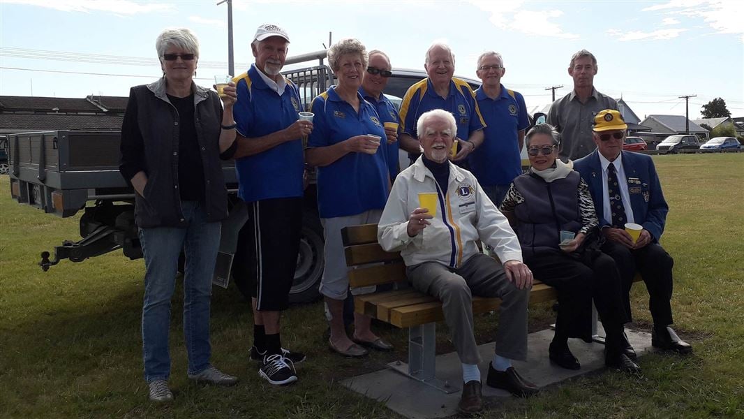 Members of the Lions Club of Napier Host with DOC Ranger Peter Abbott at the new commemorative seat on Meeanee Quay.. 