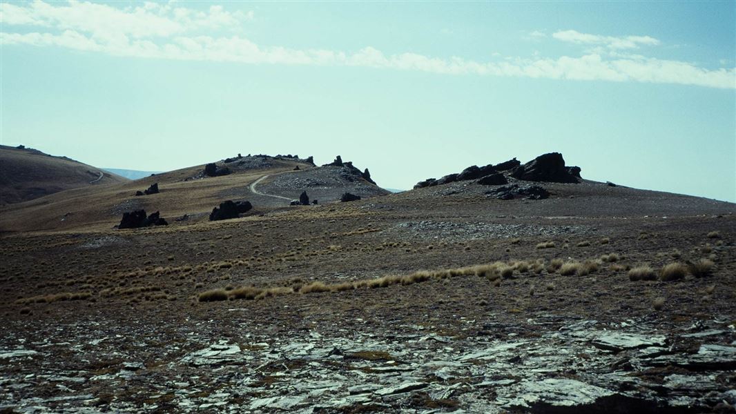 View of a track winding along the top of a rocky ridge.