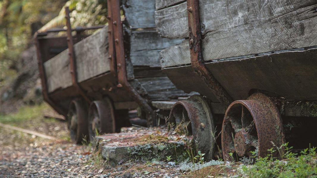 An old wooden and iron railway cart rusting and stationary.